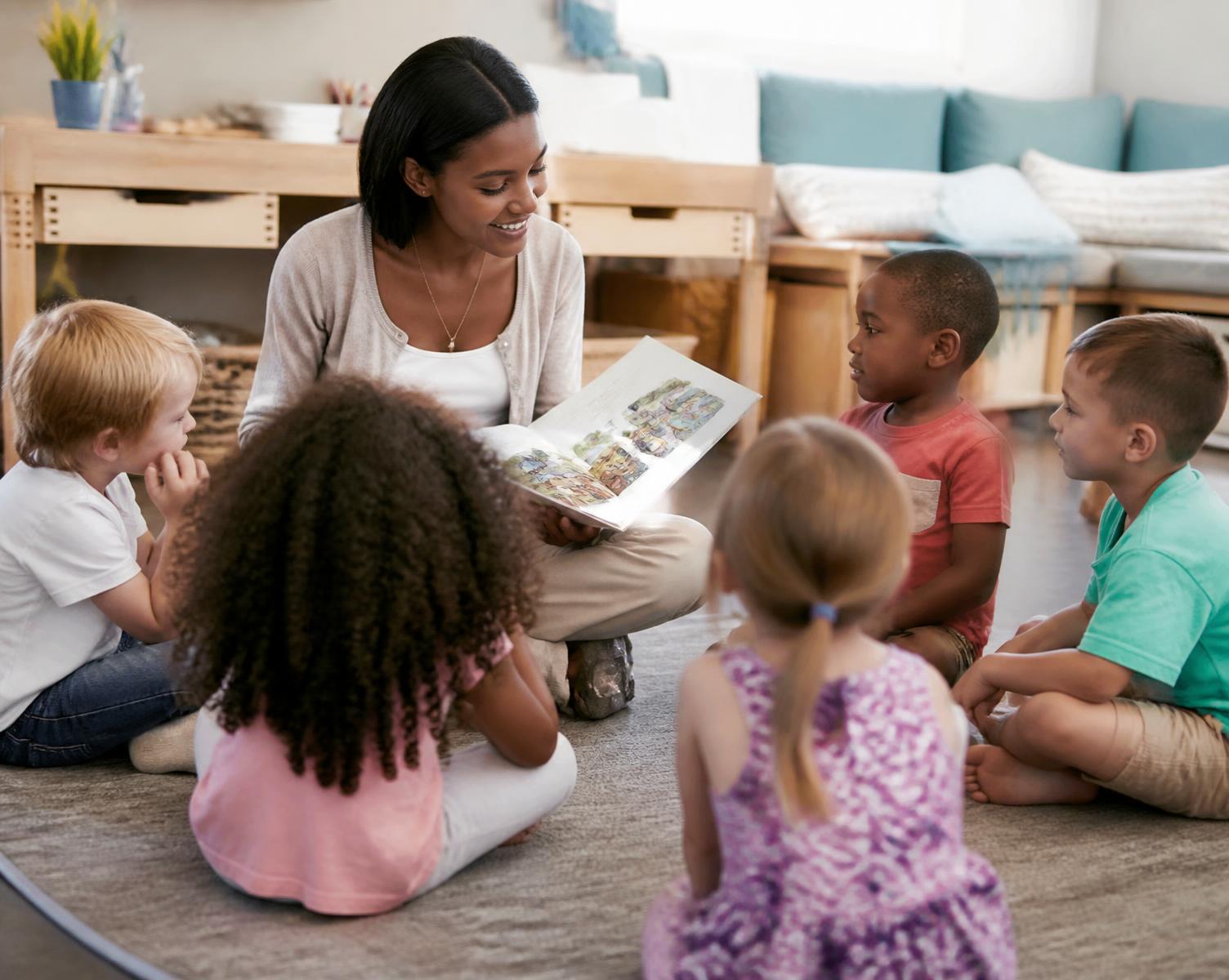 Children gathered on a mat for story time with their teacher